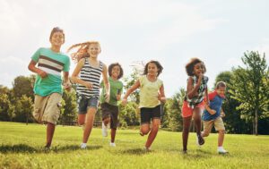 Happy, Kids, Playing, Running, Grass, Nature © PeopleImages_Shutterstock